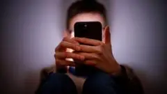 Starmer tells Apple and Google to ban nude images on children's phones