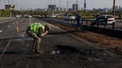 Kyiv bridge hit in further Russian drone attack as German chancellor makes surprise visit